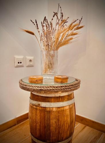 a table made out of a barrel with a vase on it at House of light in Évdhilos