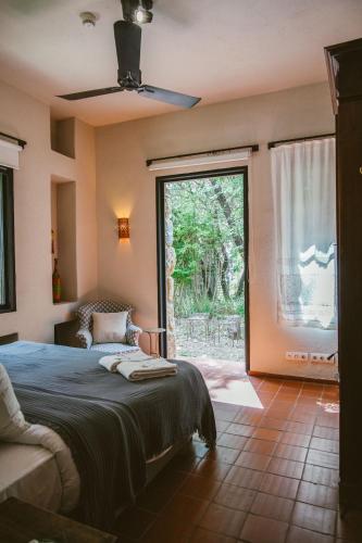 a bedroom with a bed and a large window at Bkerzay in Baakleen