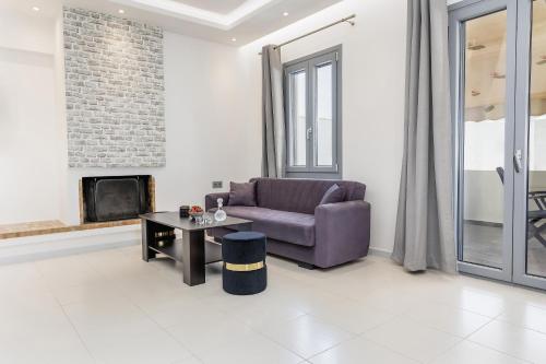 a living room with a couch and a table at simos luxury apartments in Naxos Chora