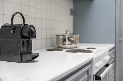 a kitchen counter with a pot on a stove at simos luxury apartments in Naxos Chora