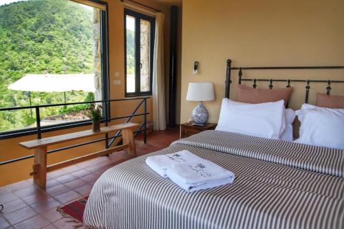 a bedroom with two beds and a window and a table at Bkerzay in Baakleen