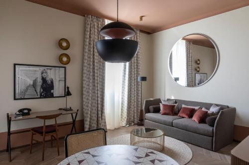 a living room with a couch and a table at Palazzo Velabro, a Member of Design Hotels in Rome