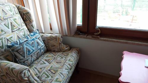 a couch sitting in a room with a window at Rüzgar Hotel in Canakkale