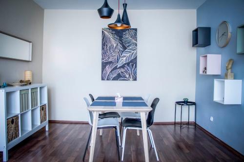a dining room with a white table and chairs at Centergom in Esztergom