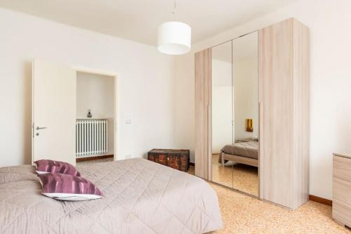 a bedroom with a large mirror and a bed at CASA TILDE Barbaresco in Barbaresco