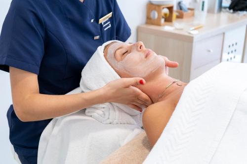 a woman in a spa receiving a facial massage at Seth Santo Tomás in Santo Tomás