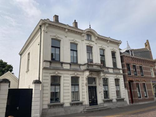 a white building on a city street at Bed & Breakfast By Genck in Oudenbosch