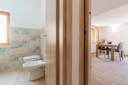 a bathroom with a toilet and a sink at Uncle Leonard's House in Cala Gonone