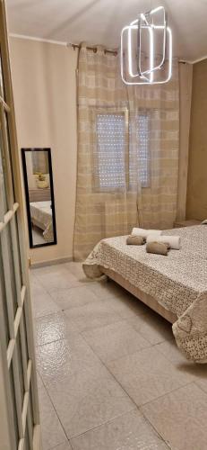 a bedroom with a bed and a chandelier at Residence San Ferdinando in San Ferdinando di Puglia