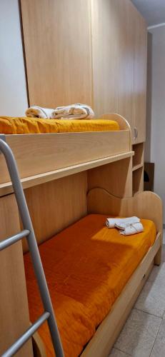 two bunk beds in a room with orange sheets at Residence San Ferdinando in San Ferdinando di Puglia