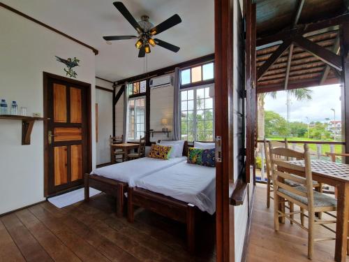 a bedroom with a bed and a ceiling fan at Greenheart Boutique Hotel in Paramaribo