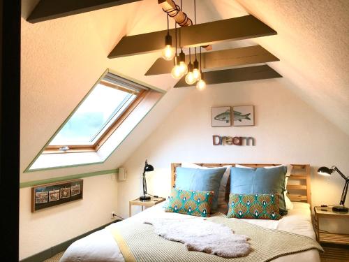 a attic bedroom with a bed with a skylight at Glaz Ocean in Douarnenez