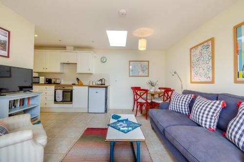 a living room with a couch and a table at Little Scarlet in East Dean
