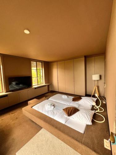 a large bedroom with a large white bed in it at B&B The White House in Wielsbeke