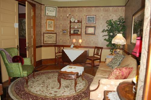 a living room with a couch and chairs at Schuster Mansion Bed & Breakfast in Milwaukee