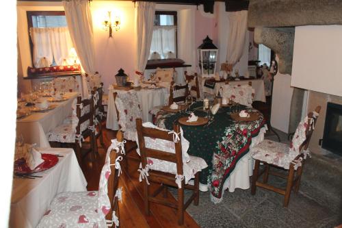 a dining room with a table and chairs with christmas decorations at Le Coeur du Pont in Donnas