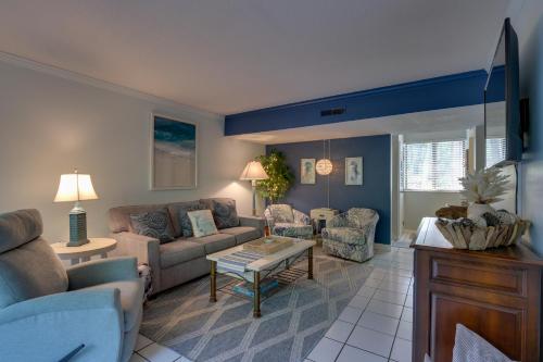 a living room with a couch and a table at Serene Hilton Head Island Condo with Community Pool! in Hilton Head Island