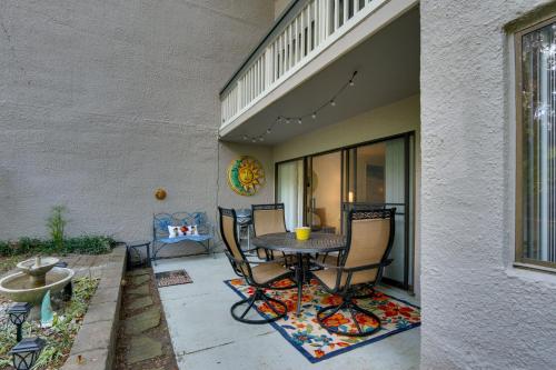 a patio with a table and chairs on a rug at Serene Hilton Head Island Condo with Community Pool! in Hilton Head Island