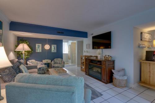 a living room with a couch and a tv at Serene Hilton Head Island Condo with Community Pool! in Hilton Head Island