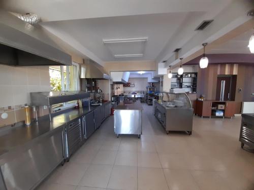 a large kitchen with stainless steel counters and appliances at Kocaali Sun Otel in Sakarya