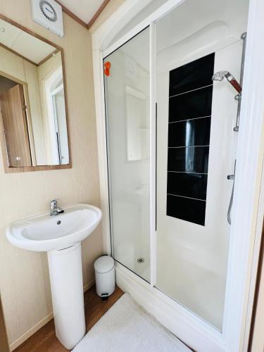 a bathroom with a sink and a shower at Haven Holiday Home at Kent Coast Allhallows in Allhallows