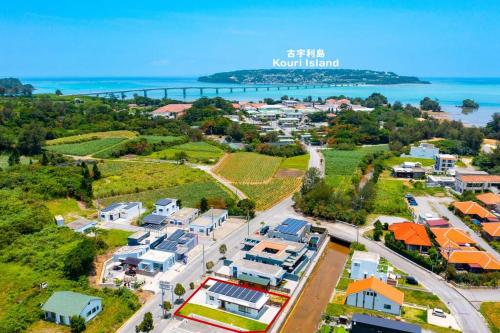 an aerial view of a small town next to the ocean at 庭付き一棟貸 ビーチまで3分 宇利島車で7分 最大8人 Luana house in Nago