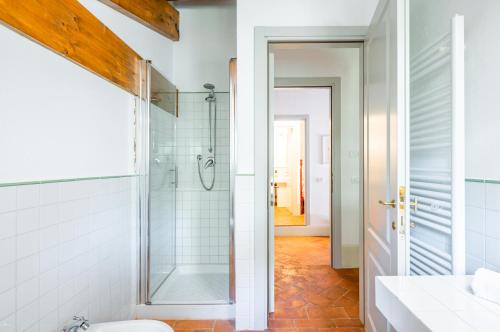 a bathroom with a glass shower and a toilet at La Serra Vitignano-Stunning Villa With Seasonal Swimming Pool! in Castelnuovo Berardenga