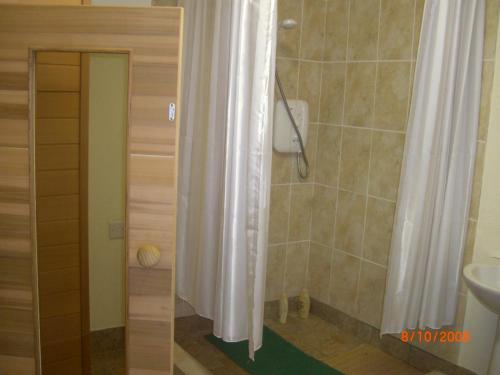 a bathroom with a shower curtain and a sink at Traditional Stone Cottage 300 years+ in Galway