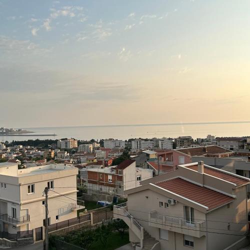 a city with buildings and the ocean in the background at Akapulco Apartments in Bar