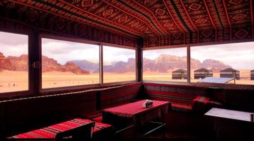 a room with a table and a view of the beach at joy of life in Wadi Rum