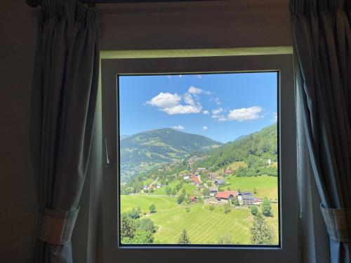 a window with a view of a mountain view at Landhaus Schönblick in Radenthein