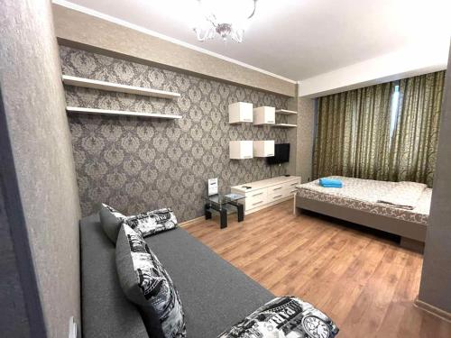 a small room with a bed and a bedroom with a bed sqor at HomeService Apartments on Stefan cel Mare boulevard in Chişinău
