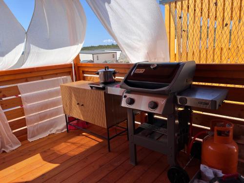 a grill sitting on the deck of a boat at Green Turtle Holiday - Lovely, brand new holiday home near the sea in Drage