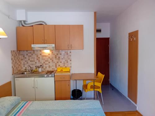 a small kitchen with a sink and a table at Vila Centar in Trebinje