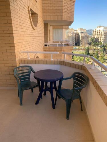 a table and two chairs sitting on a balcony at Cala Blanca on the beach in El Borseral