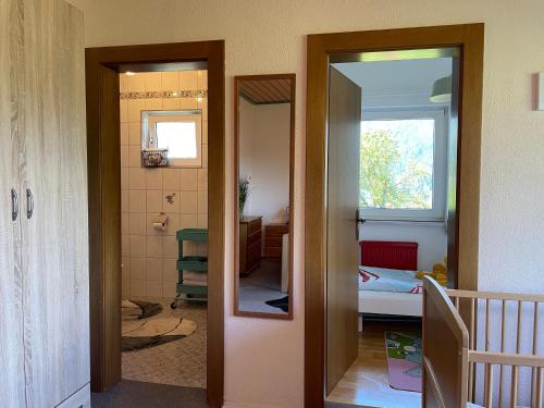 a hallway with a mirror and a bathroom at Landhaus Schönblick in Radenthein