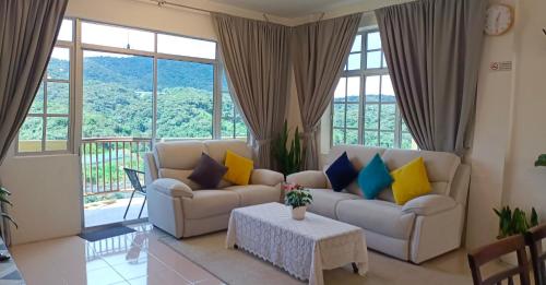 a living room with a couch and a table at Dream 1 in Cameron Highlands