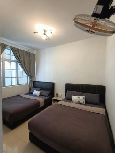 a bedroom with two beds and a ceiling at Dream 1 in Cameron Highlands