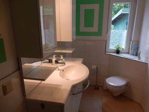 a bathroom with a sink and a toilet at Apartment Haus 25 in Velten