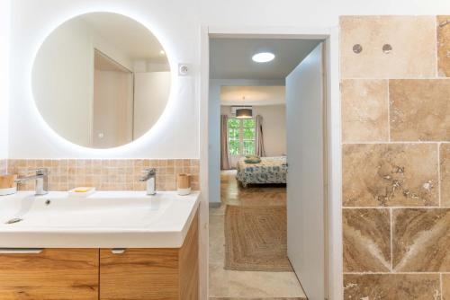 W łazience znajduje się umywalka i lustro. w obiekcie Mas du Petit Duc w mieście Cavaillon