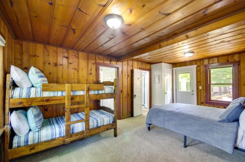 a bedroom with two bunk beds in a cabin at Dock and Boat Slip Lakefront Osage Beach Home! in Osage Beach