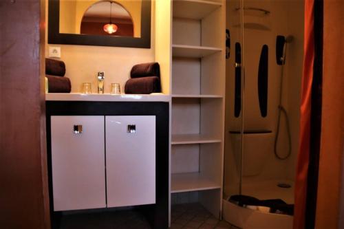 a bathroom with a white sink and a shower at Chambre Meknes, Riad 7 au village naturiste Couple only in Cap d'Agde