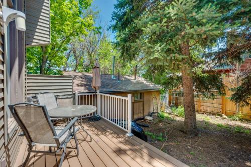 a patio with a table and chairs on a deck at Beautiful Boulder Townhome Walk to CU and Pearl St! in Boulder