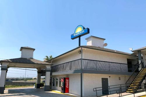 a gas station with a sign on top of it at Days Inn by Wyndham San Antonio Interstate Hwy 35 North in San Antonio