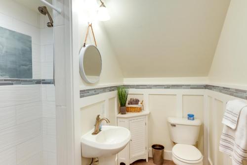 a bathroom with a sink toilet and a mirror at Sheboygan Getaway with Deck and On-Site Lake Access! in Sheboygan