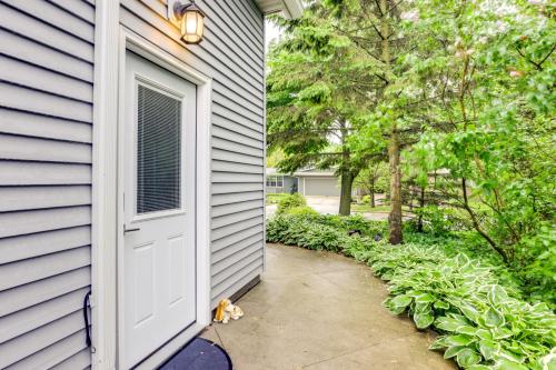 a white door on a house with a driveway at Sheboygan Getaway with Deck and On-Site Lake Access! in Sheboygan