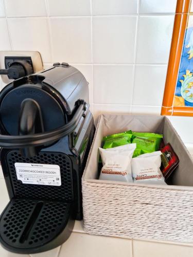 a toaster sitting on a counter next to a basket at Varigotti Tropical Garden - full floor apartment in Varigotti