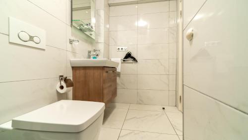 a bathroom with a toilet and a sink and a shower at Bertiz Mignon in Bozcaada