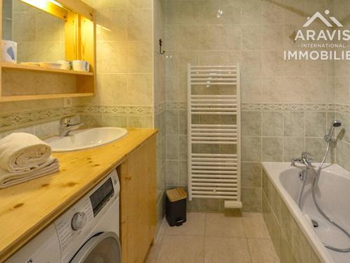 a bathroom with a sink and a washing machine at Appartement Le Grand-Bornand, 5 pièces, 8 personnes - FR-1-391-41 in Le Grand-Bornand