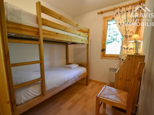 a bedroom with two bunk beds and a window at Appartement Le Grand-Bornand, 5 pièces, 8 personnes - FR-1-391-41 in Le Grand-Bornand